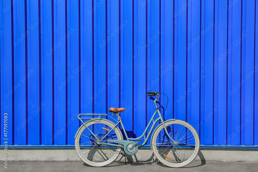 Retro bicycle near blue wall outdoors Retro bicycle near blue wall outdoors
