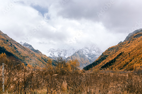 Mountain landscape with road of golden autumn. Caucasus Mountains, Dombay