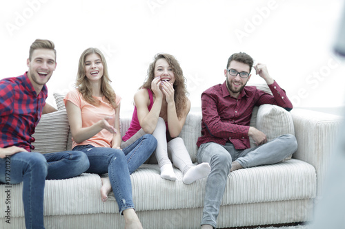 group of cheerful friends watching their favorite movie