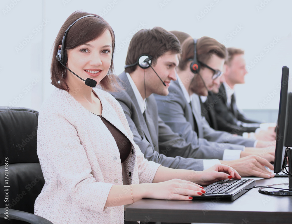 beautiful woman assistant with a headset in a call center on the beautiful woman assistant with a headset in a call center on the