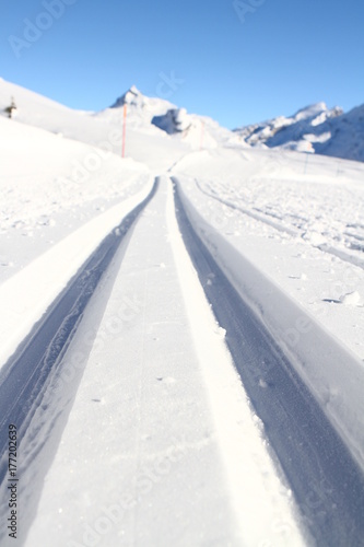 SKI TRACE IN SNOW COVERED MOUNTAIN LANDSCAPE