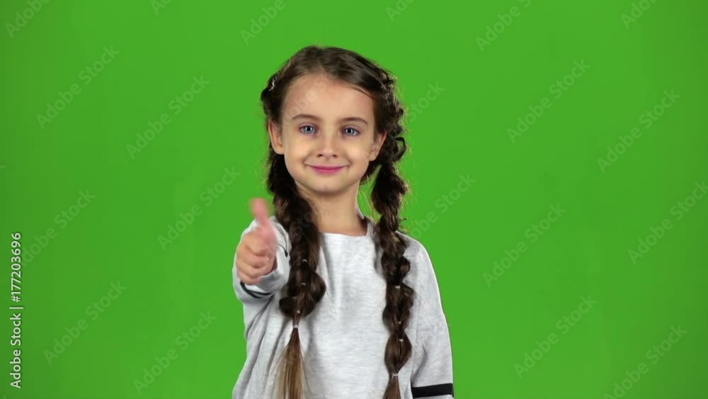 Child girl shows thumbs up. Green screen. Slow motion Child girl shows thumbs up. Green screen. Slow motion