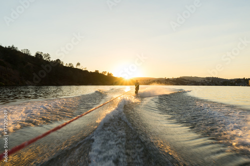 Canvas Print A water skier takes a run at sunset on a glassy lake