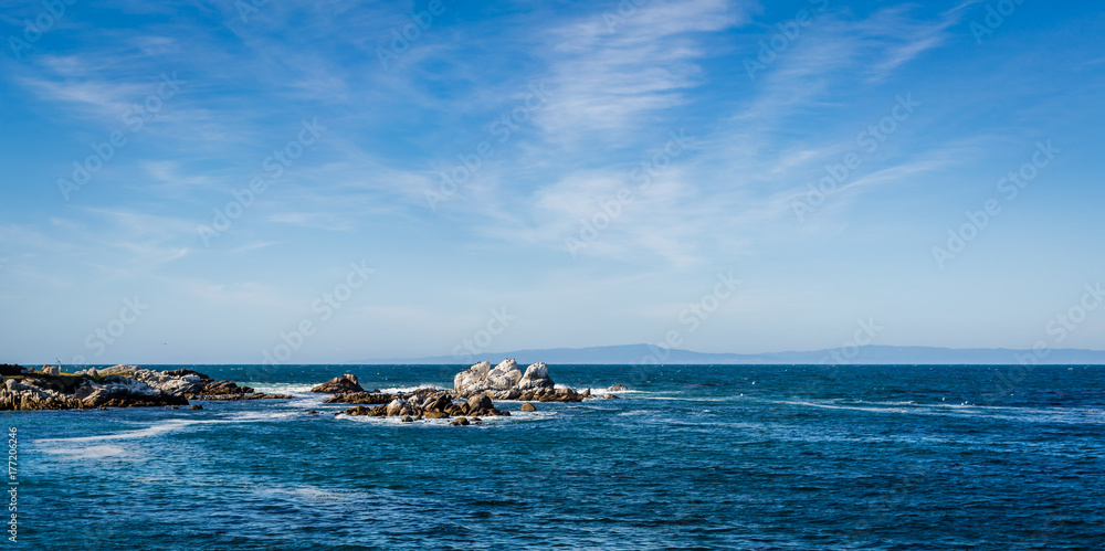 Waves crashing on rocks in Monterey Bay, California