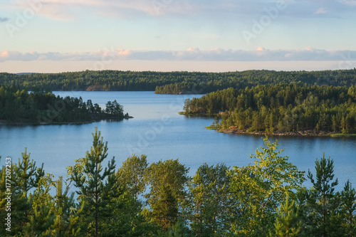 Fototapeta Naklejka Na Ścianę i Meble -  Summer evening landscape from the high shore of Ladoga lake in the skerries to the bay of Lehmalahti and the islands