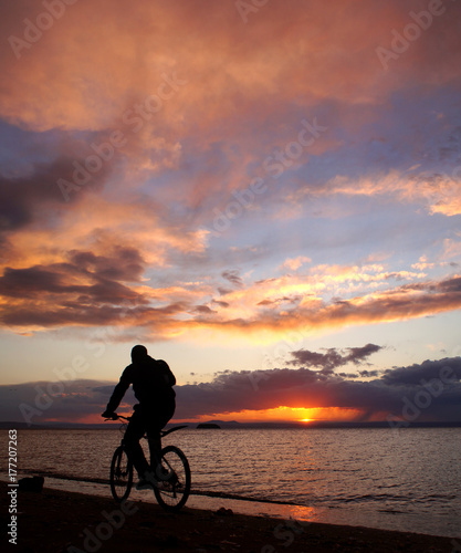 Bike trail with sunset on the sea view © Jane Savinova