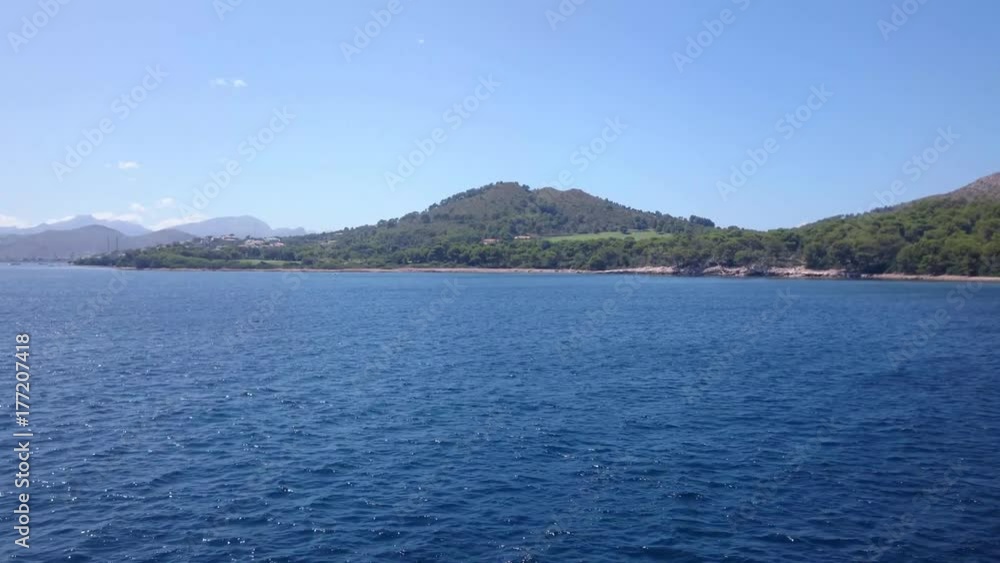 Mediterranean shoreline and blue sea as seen from a moving boat in Formentor Mallorca Spain Mediterranean shoreline and blue sea as seen from a moving boat in Formentor Mallorca Spain