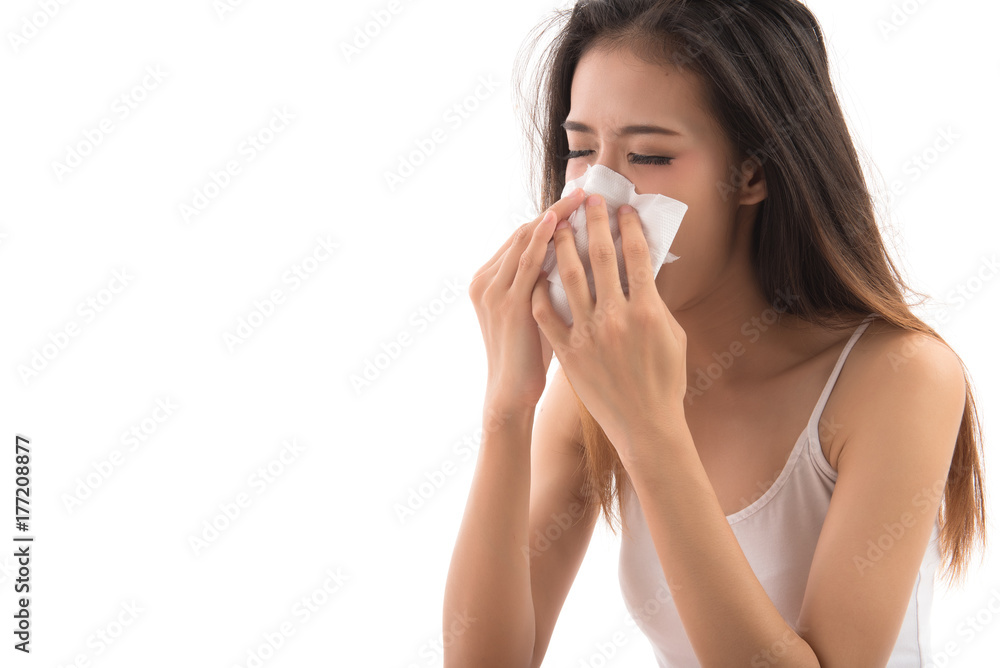Flu cold or allergy symptom. Sick young woman girl sneezing in tissue isolated on white background. Asian woman use of the tissue. Health care concept. Studio shot. Flu cold or allergy symptom. Sick young woman girl sneezing in tissue isolated on white background. Asian woman use of the tissue. Health care concept. Studio shot.