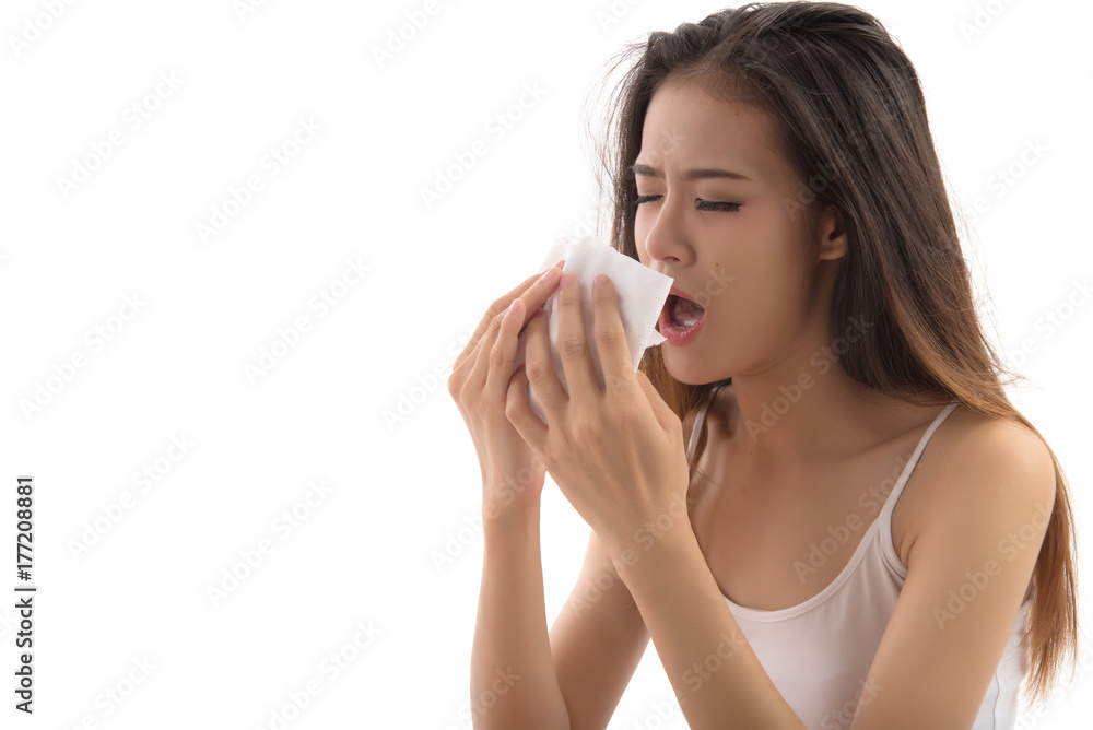 Flu cold or allergy symptom. Sick young woman girl sneezing in tissue isolated on white background. Health care concept. Studio shot. Free from copy space. Flu cold or allergy symptom. Sick young woman girl sneezing in tissue isolated on white background. Health care concept. Studio shot. Free from copy space.