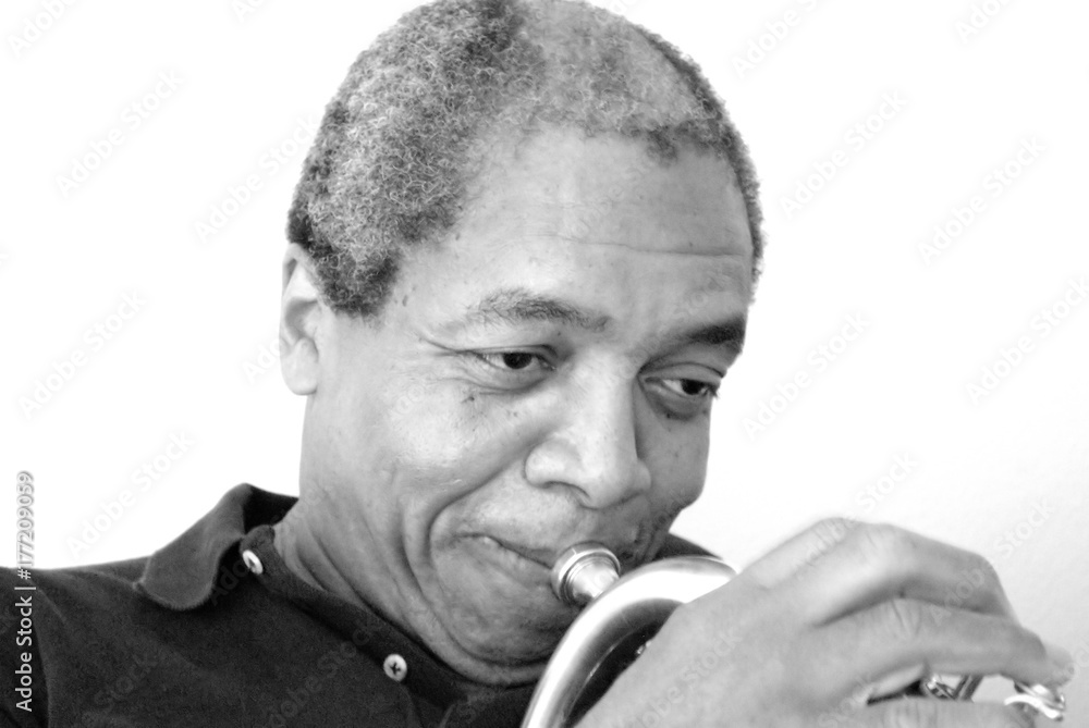 African american jazz musician with his flugelhorn indoors.