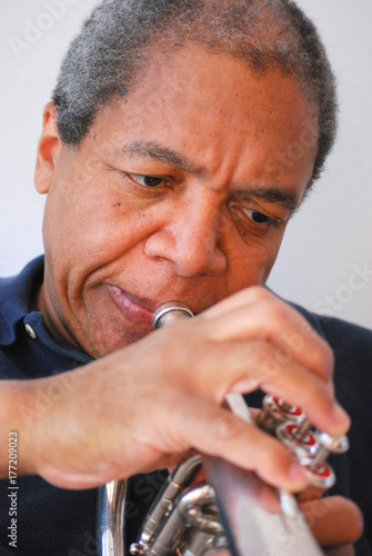 Photography African american jazz musician with his flugelhorn indoors.