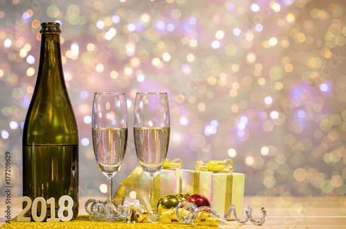 Wallpaper Mural Bottle of champagne and glasses are placed together with a gift box and shiny balls. There is wooden texts "2018". Space on top right for your wording. Torontodigital.ca