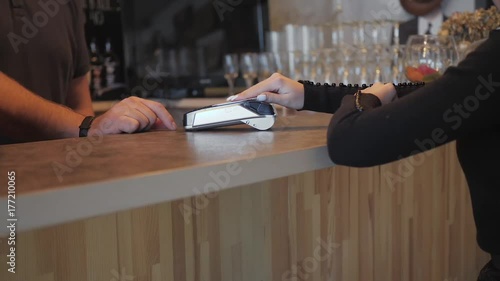 Concept NFC contactless payment. Making payment with credit card and pos terminal, printed check.