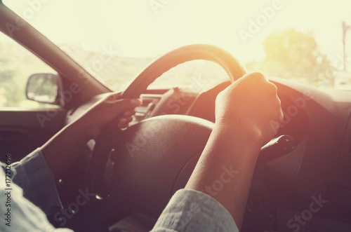 vintage filter style of female drive car and sunset