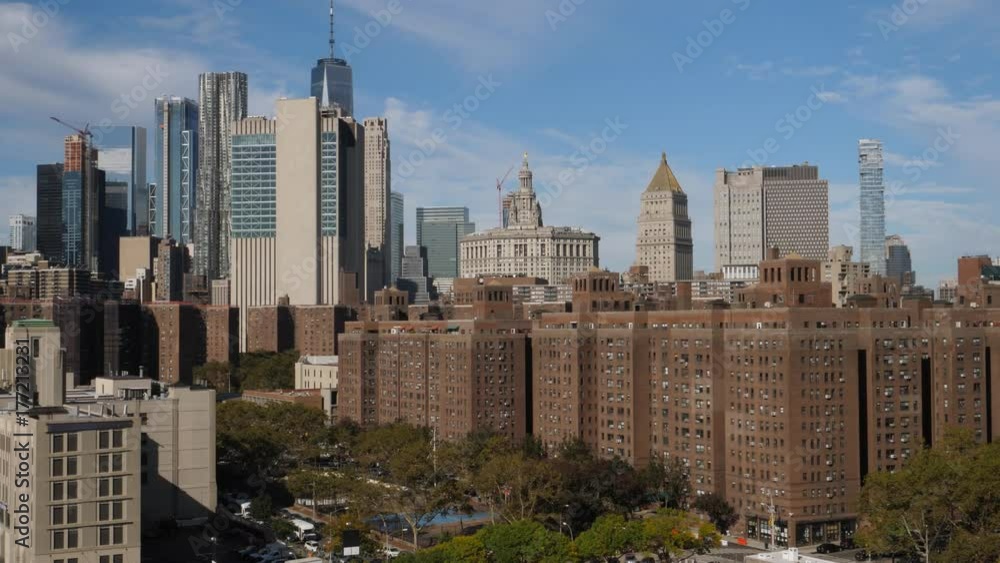 A high angle daytime establishing shot (DX) of the buildings and apartments in Manhattan's Two Bridges neighborhood. The financial district skyline and Freedom Tower in the distance. A high angle daytime establishing shot (DX) of the buildings and apartments in Manhattan's Two Bridges neighborhood. The financial district skyline and Freedom Tower in the distance.