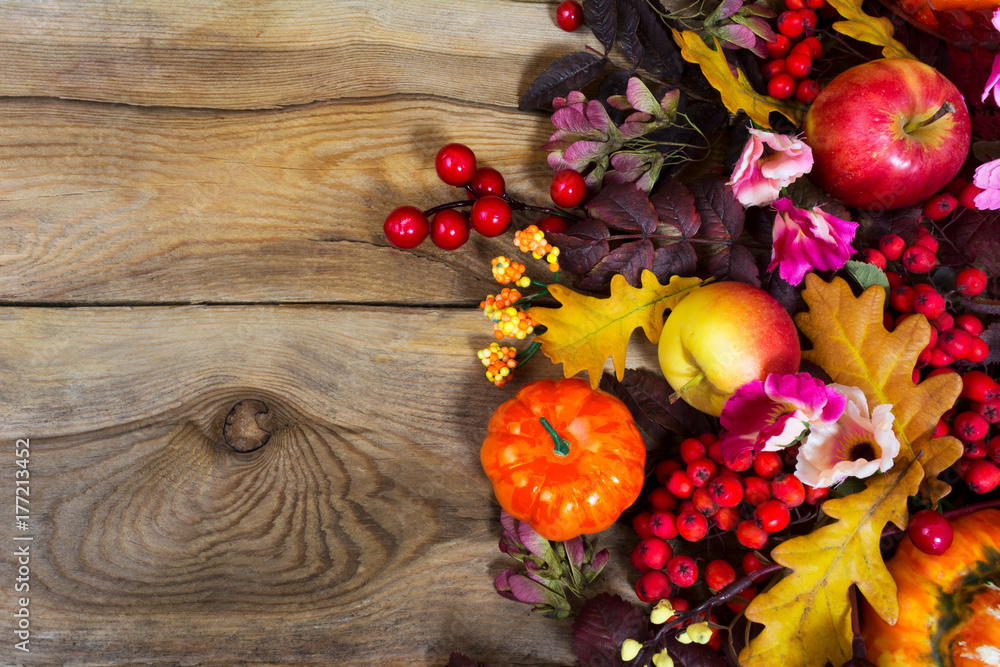 Fall decoration with yellow oak leaves, red berries, pink flowers, copy space Fall decoration with yellow oak leaves, red berries, pink flowers, copy space