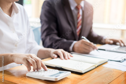 Administrator business man financial inspector and secretary making report, calculating balance. Internal Revenue Service checking document. Audit concept.