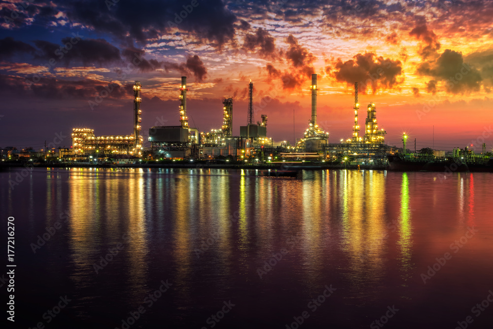 Oil and gas industry - refinery at Sunrise - factory - petrochemical plant with reflection over the river