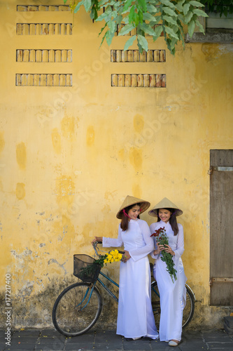 Beautiful woman with Vietnam culture traditional dress,Ao dai is famous traditional costume ,vintage style,Hoi an Vietnam