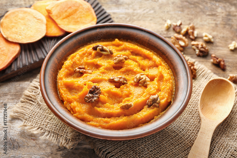 Bowl with mashed sweet potato on table