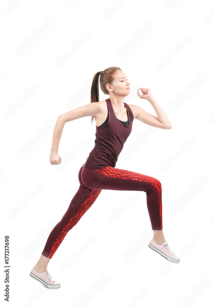 Young sporty woman running on white background