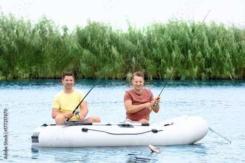 Two men fishing from inflat...