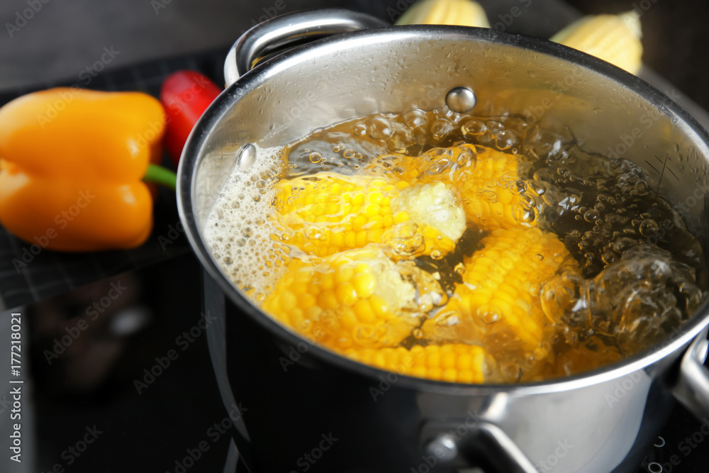 Saucepan with corn cobs on stove Saucepan with corn cobs on stove