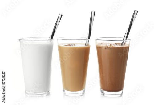 Glasses with protein shakes on white background