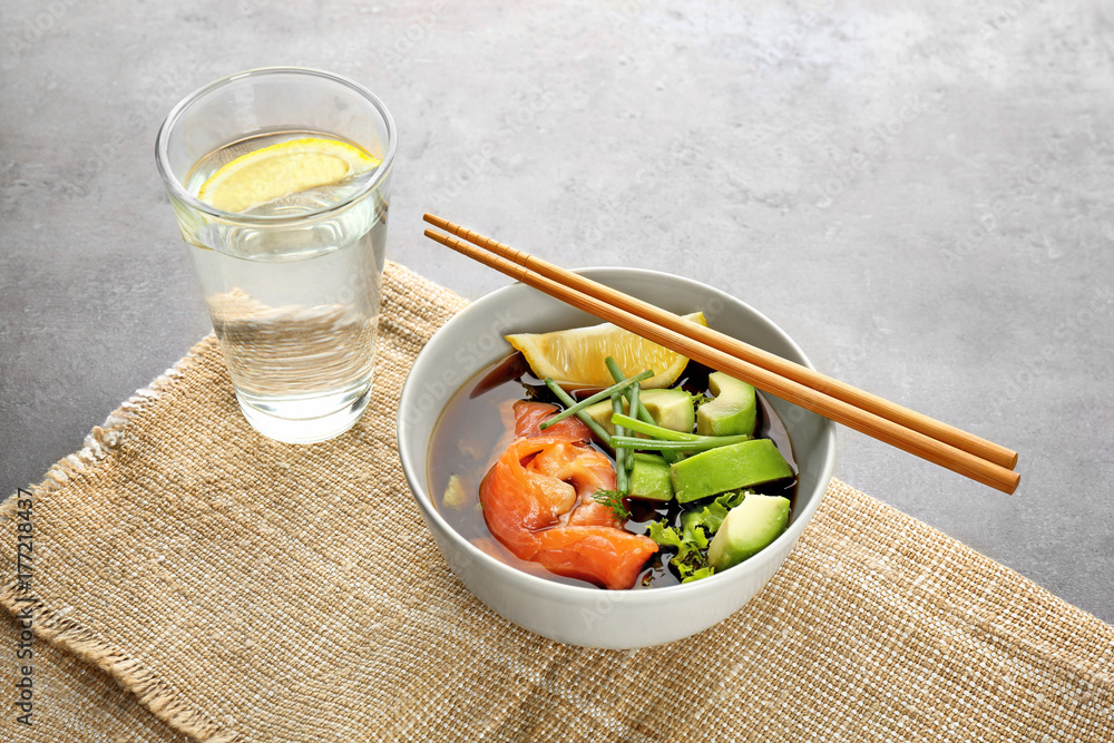 Bowl with delicious salmon salad on table Bowl with delicious salmon salad on table
