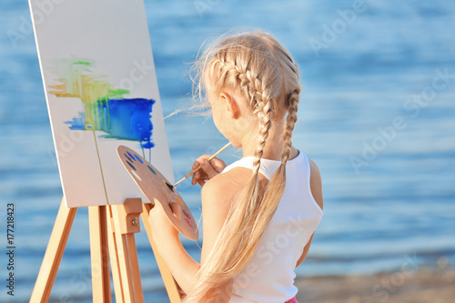 Cute little girl painting p...