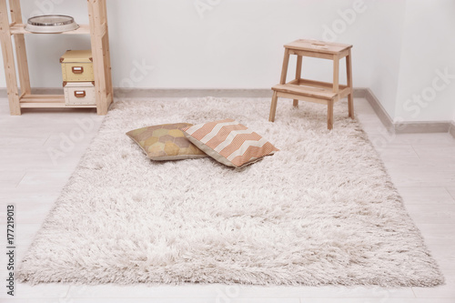 Fotografie White soft carpet on floor indoors