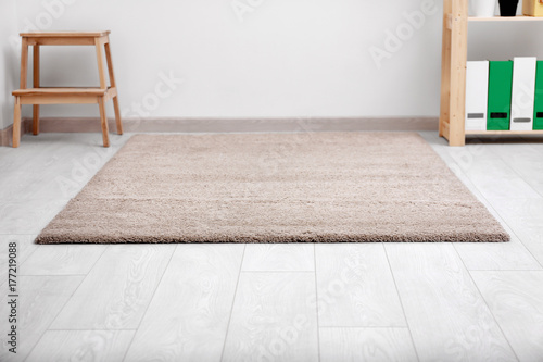 Fotografie Beautiful light carpet on floor indoors