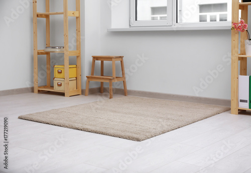 Fotografie Beautiful light carpet on floor indoors