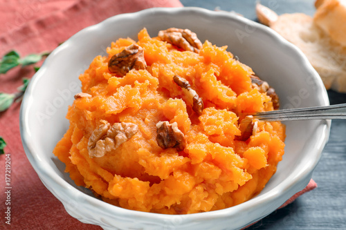 Bowl with mashed sweet potato on table, closeup