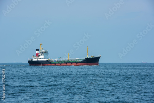 oil tanker  gas tanker in the high sea.Refinery Industry cargo ship. top view aerial view Thailand  in import export  LPG oil refinery  Logistics and transportation with working crane bridge in harbor