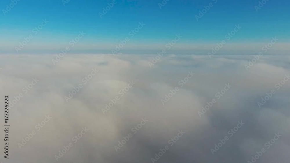 Aerial View. Flying in fog, fly in mist. Aerial camera shot. Flight above the clouds towards the sun. Misty weather, view from above. Aerial View. Flying in fog, fly in mist. Aerial camera shot. Flight above the clouds towards the sun. Misty weather, view from above.