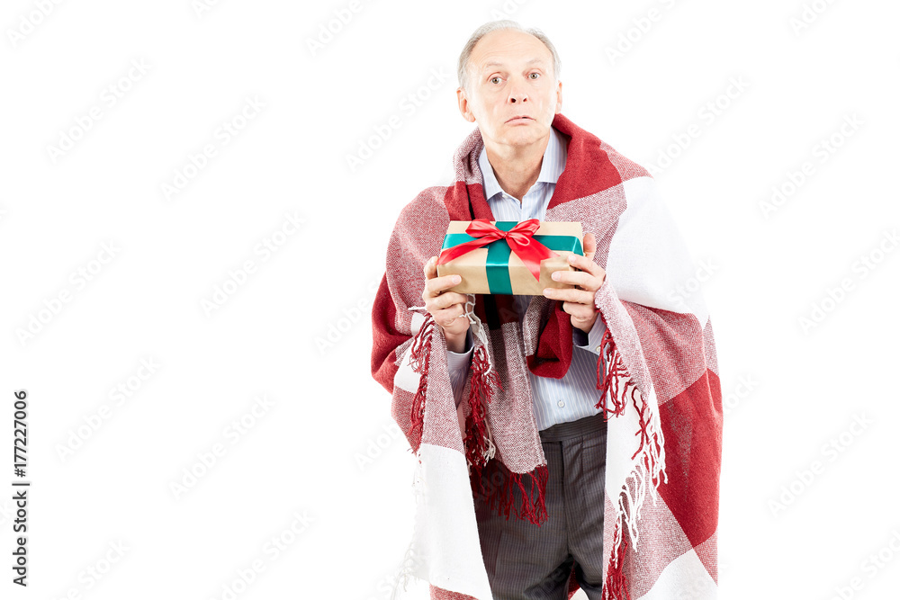 Portrait of senior man wrapped in blanket holding Christmas gift Portrait of senior man wrapped in blanket holding Christmas gift