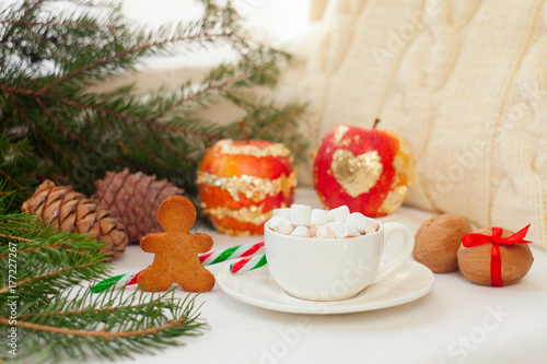 festive new year and Christmas decoration on white background, cup of cocoa with marshmallow, ginger bread cookies and Christmas apple.