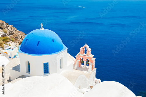 White church with blue domes on Santorini island, Greece.
