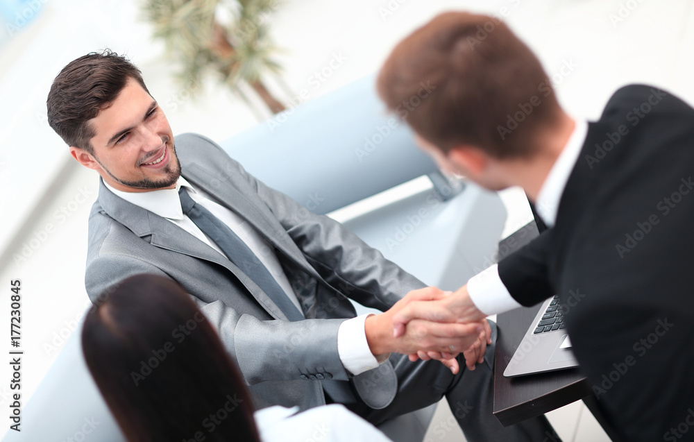 handshake business partners in the lobby of the office. handshake business partners in the lobby of the office.