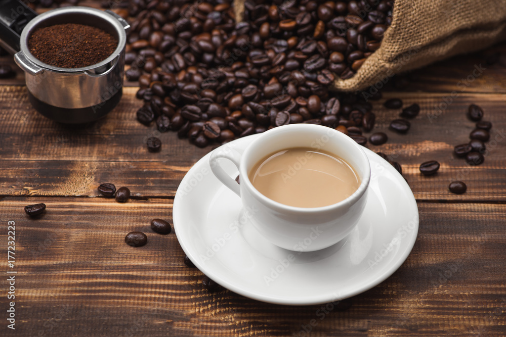 Coffee cup and beans on a rustic background Coffee cup and beans on a rustic background