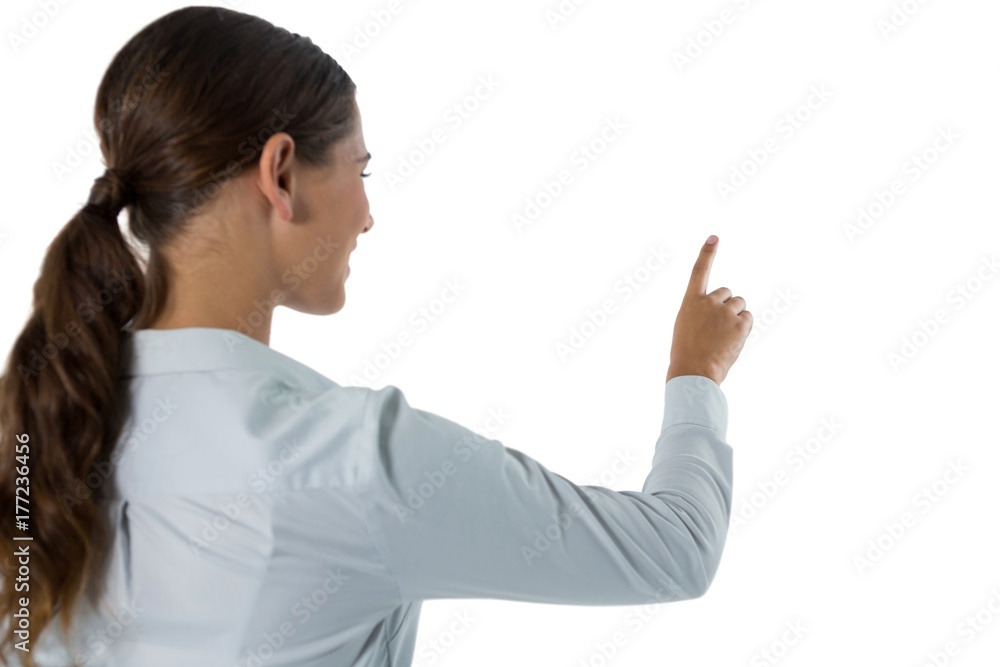 Female executive pretending to touch an invisible Female executive pretending to touch an invisible