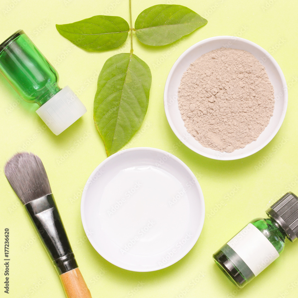 Top view of different cosmetics products on yellow background Top view of different cosmetics products on yellow background