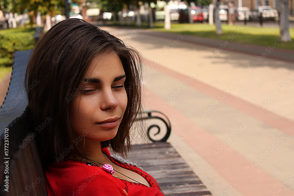 Fototapeta premium Beautiful girl on a street in the city avenue. Portrait of a brunette