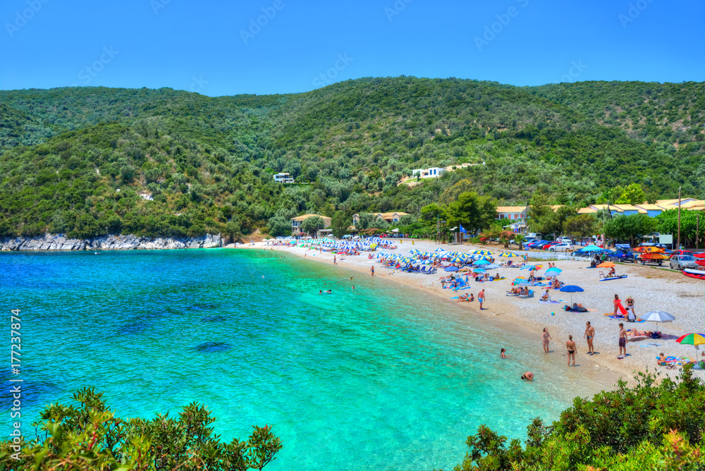 People on the beach in summer holiday in Mikros Poros village of ...