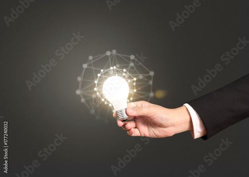 holding lightbulb in hand