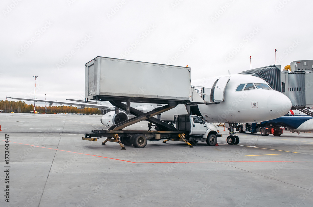 Fototapeta premium The aircraft is on service after a flight in the parking at the airport