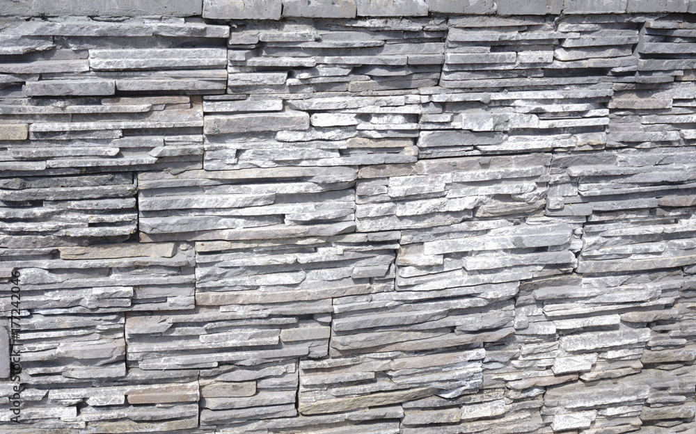 Fototapeta premium Stone background of decorative wall made of sandstone