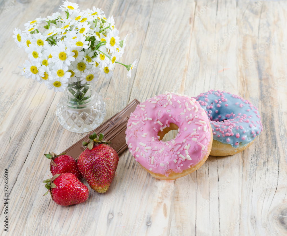 Strawberries on the table. Red strawberries on a wooden table in a glass vase. chocolate and soft buns. Strawberries on the table. Red strawberries on a wooden table in a glass vase. chocolate and soft buns.