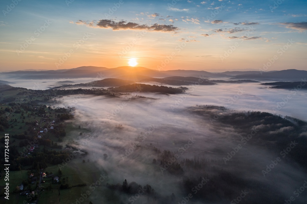 Beautiful foggy sunrise in mountains.